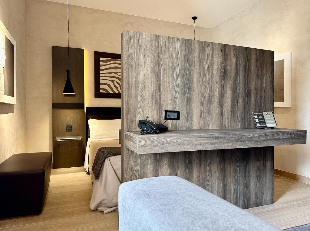 a hotel room with a reception desk in a bedroom at Hotel Capo San Vito by Geocharme in San Vito lo Capo