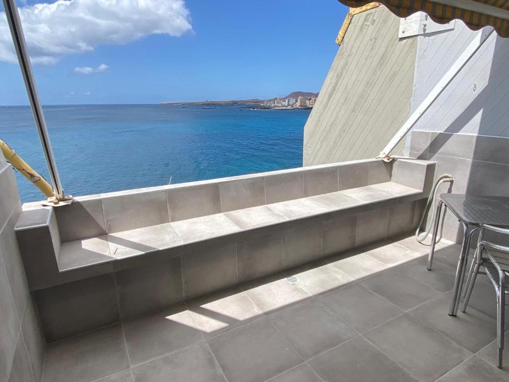 a bench on a balcony overlooking the ocean at Listen the TIDE -201 A in Costa Del Silencio