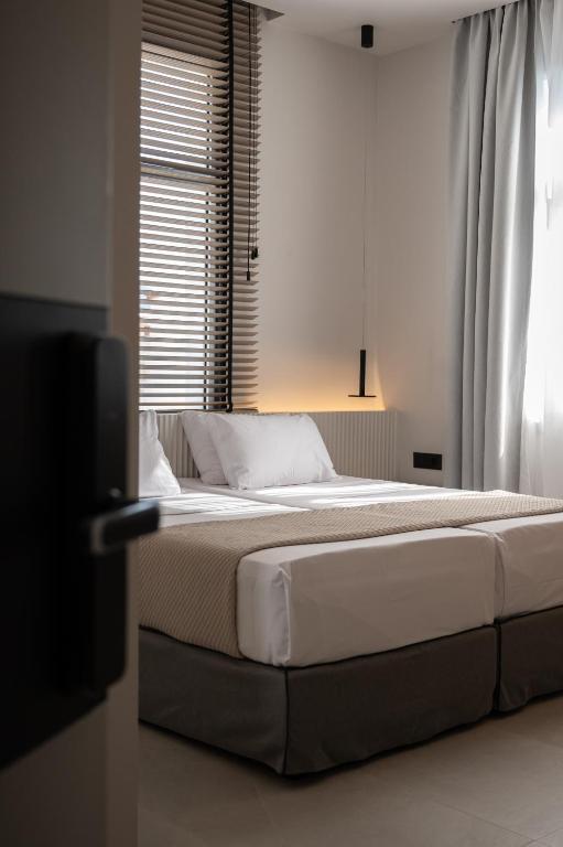 Posteľ alebo postele v izbe v ubytovaní Palladion Boutique Hotel