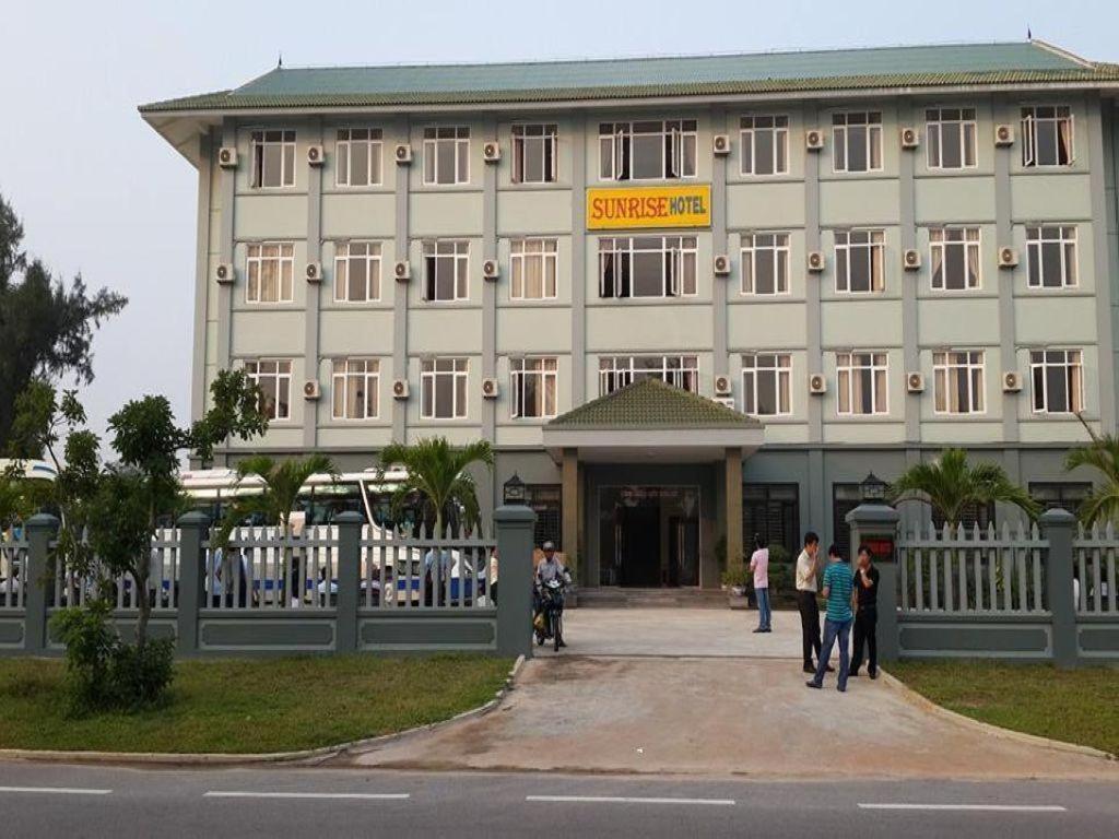 a large building with people standing in front of it at Sunrise Hotel in Dong Hoi