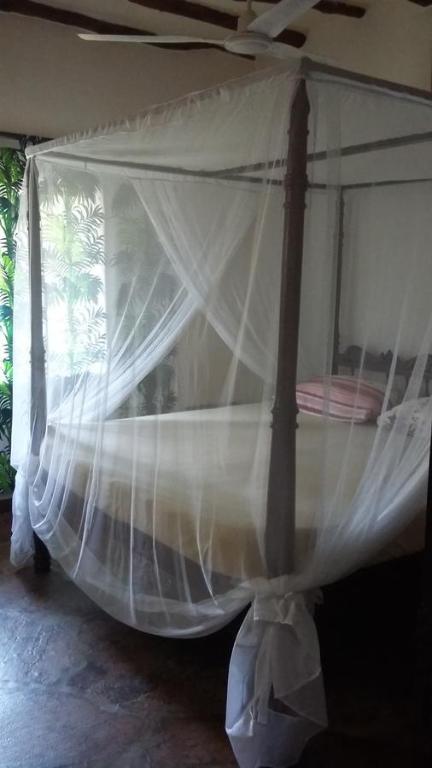 Postel nebo postele na pokoji v ubytování Villa Fortuna Malindi