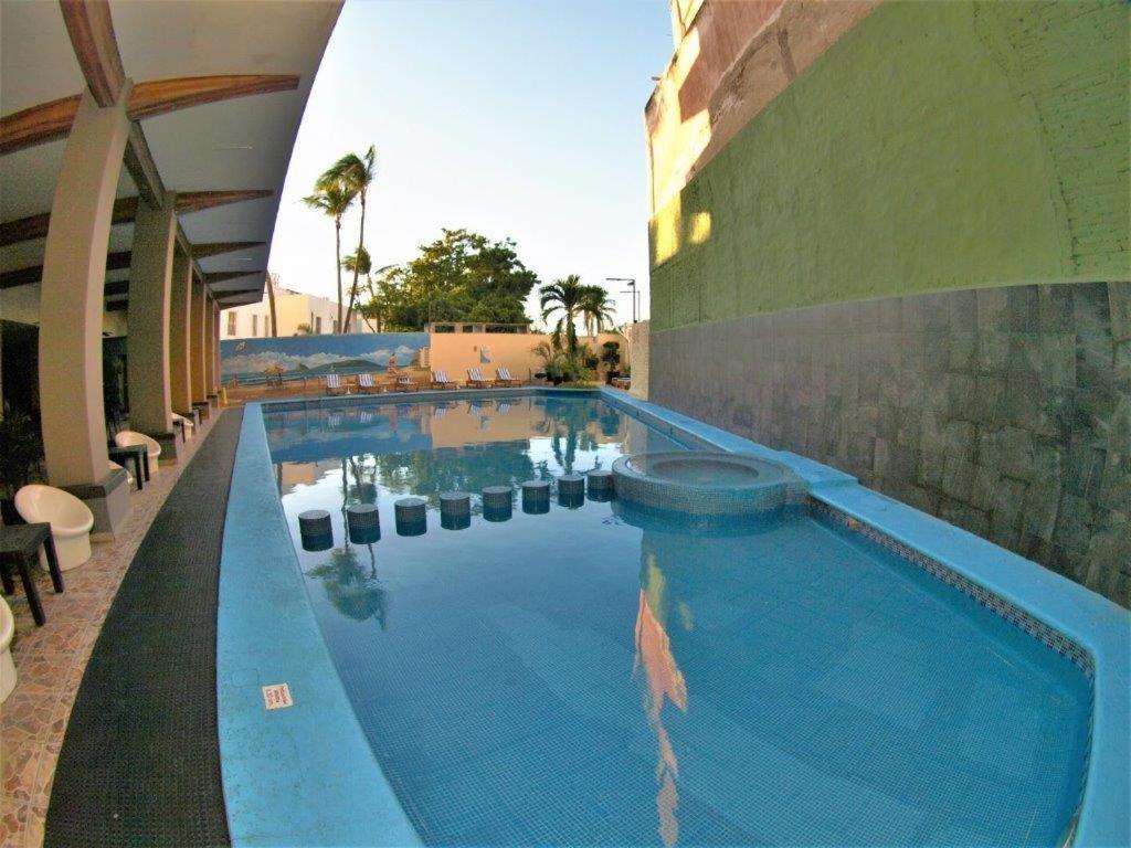 a large swimming pool next to a building at Hotel Playa Bonita in Mazatlán