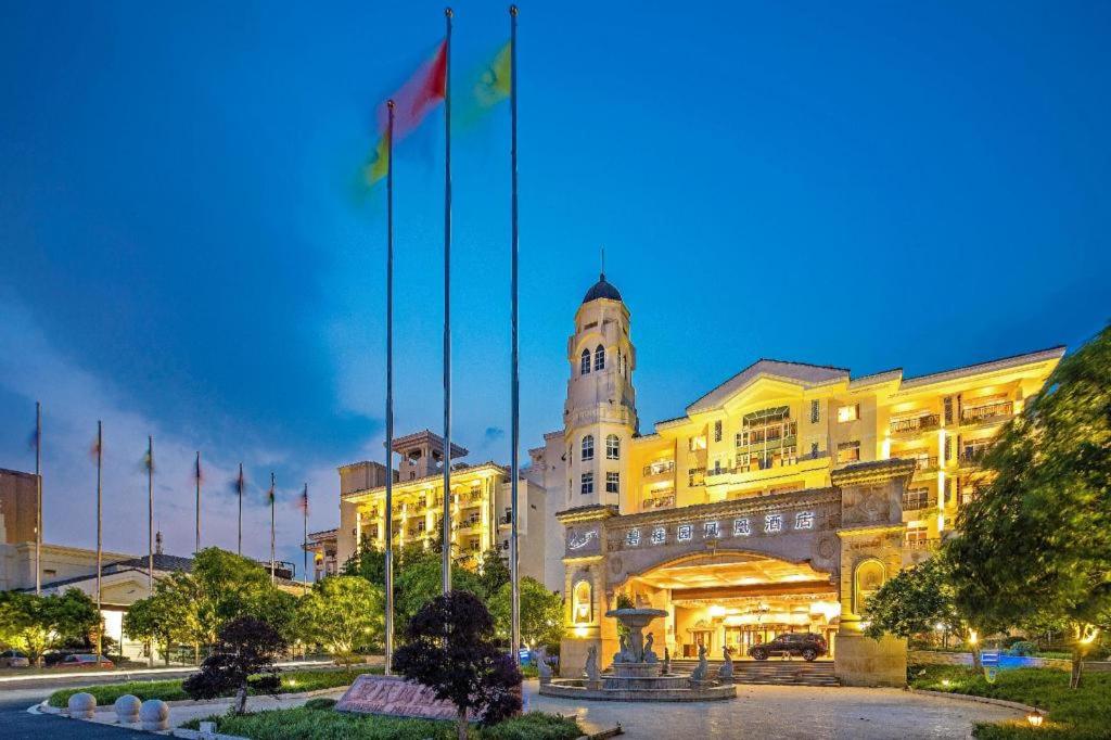 a large building with flags in front of it at Country Garden Phoenix Hotel Anqing in Renyuexing