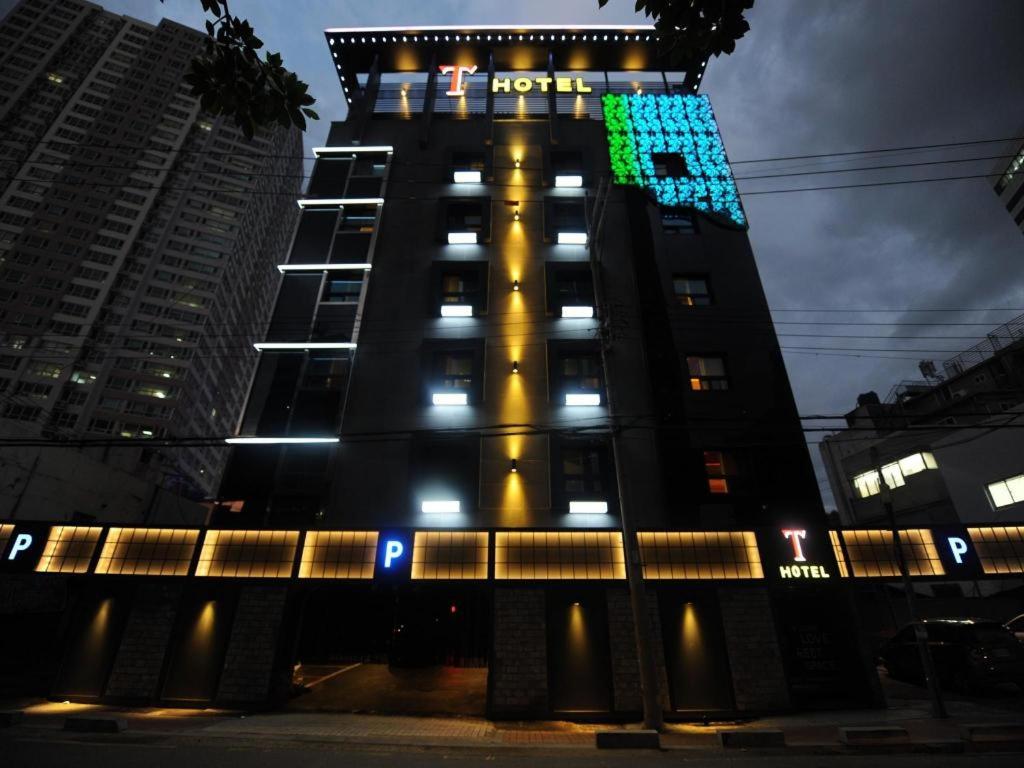 a tall building with a clock on the side of it at T Hotel in Busan