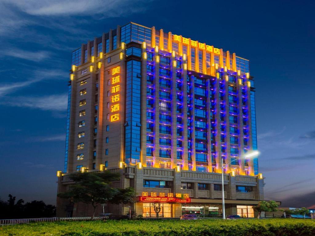a tall building with lights on it at night at MeiQiu-Fino Hotel in Zhuhai