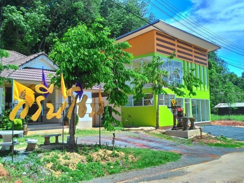 a house with a green and orange at Green Home Resort in Surat Thani