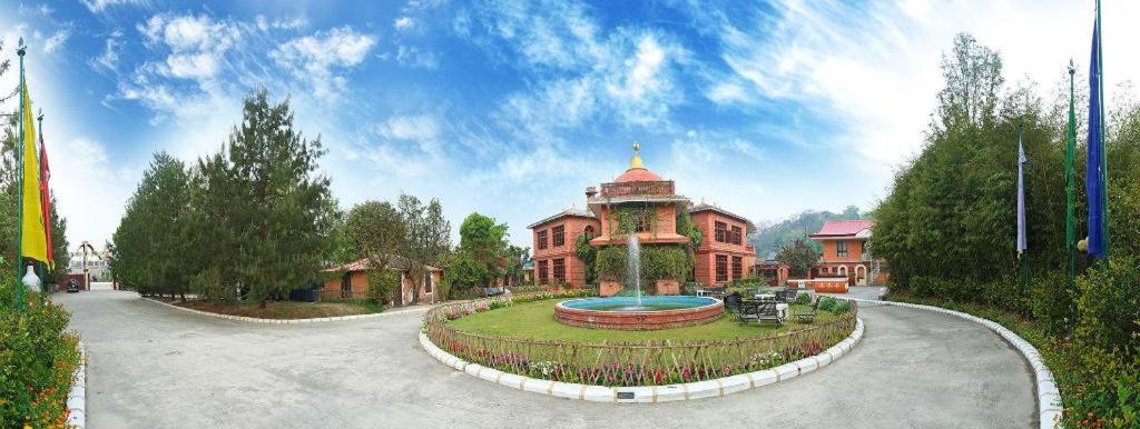 a large building with a fountain in front of it at Grand Norling Hotel's Resort in Kathmandu