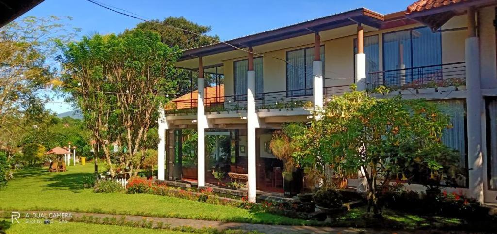 une grande maison avec une pelouse devant dans l'établissement La Oma, à Bandung