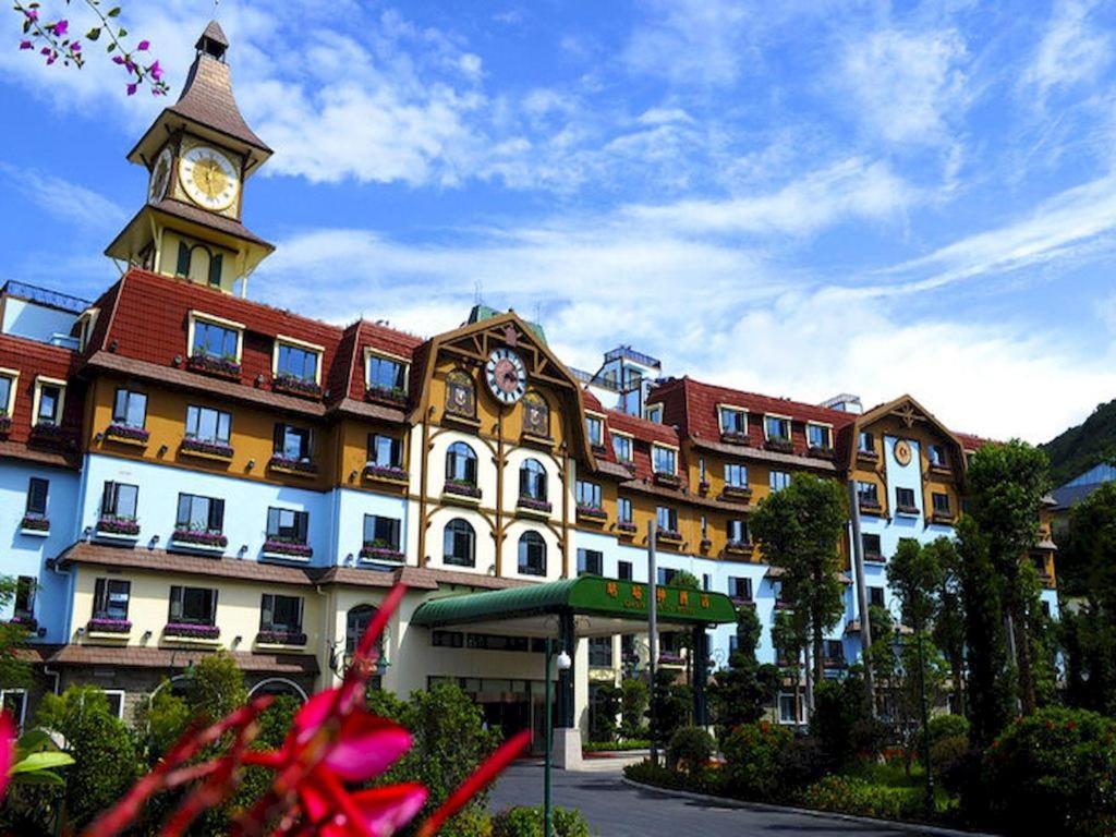a large building with a clock tower on top of it at Oasis O.City Hotel in Shenzhen