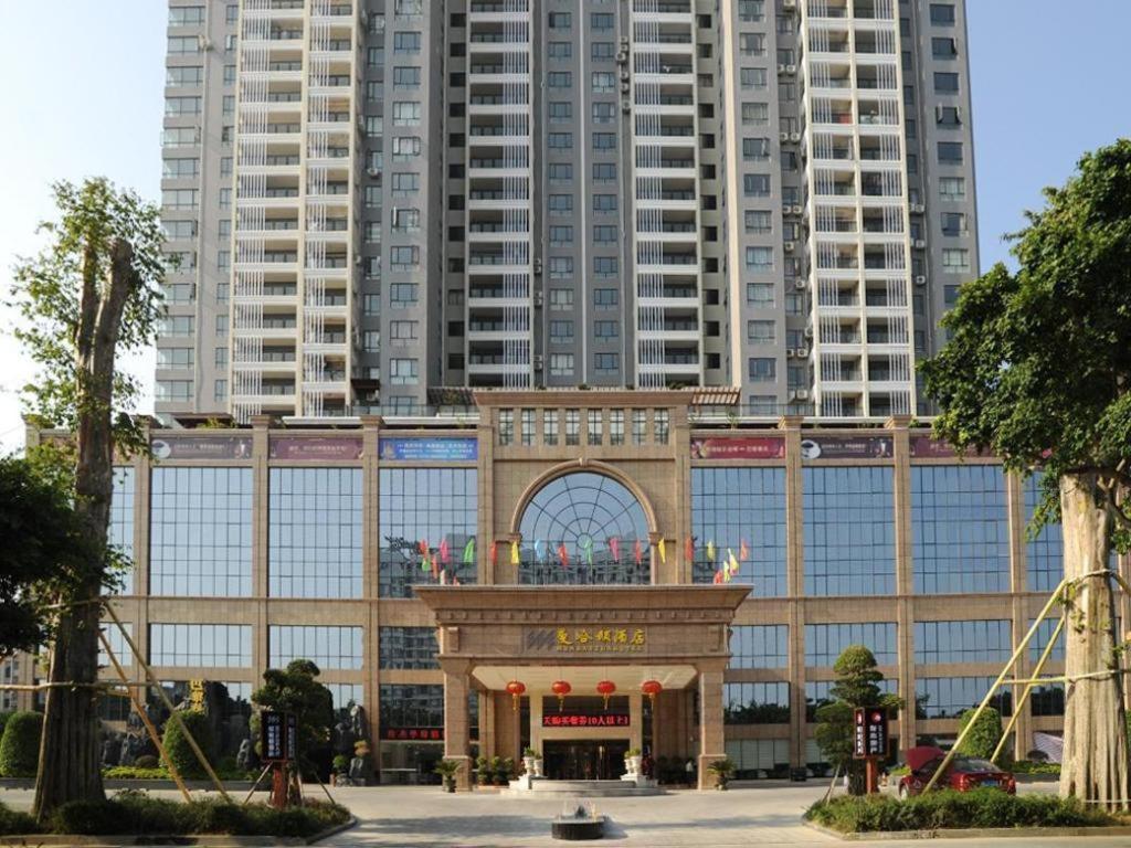a building in front of some tall buildings at Manhatton Hotel Beihai in Beihai