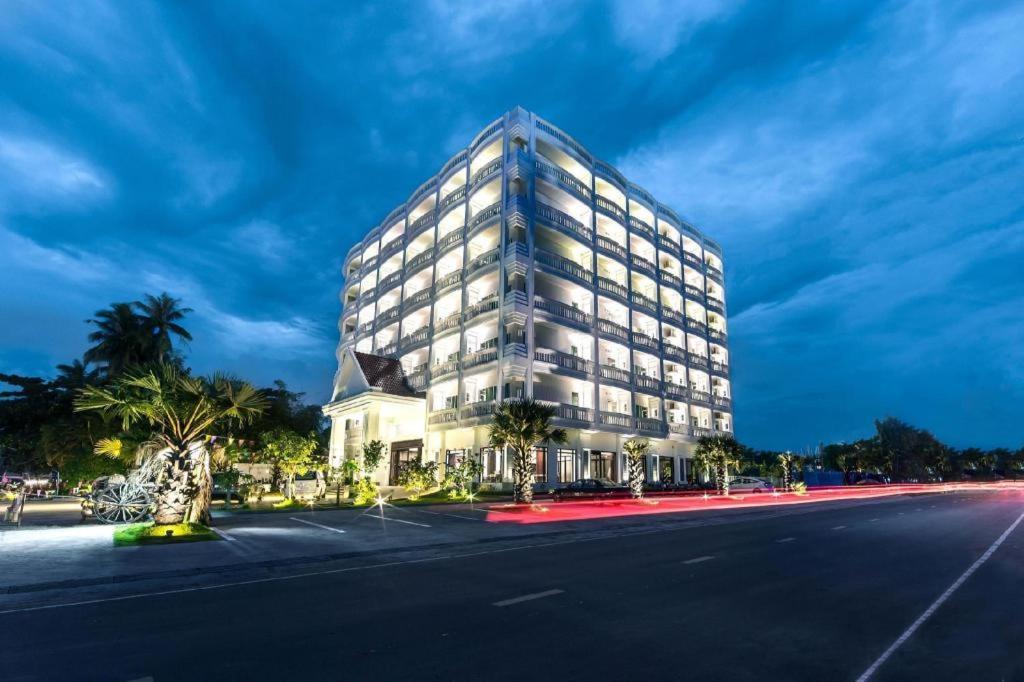 a tall building on the side of a street at The Palm Hotel in Sihanoukville