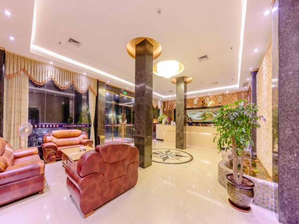 a living room with leather furniture and a lobby at Shang Pin Holiday Inn in Guangzhou