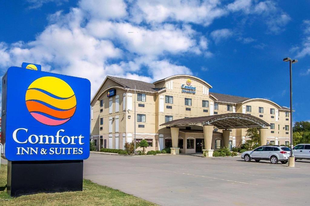 a comfort inn and suites sign in front of a building at Comfort Inn & Suites Atoka in Atoka