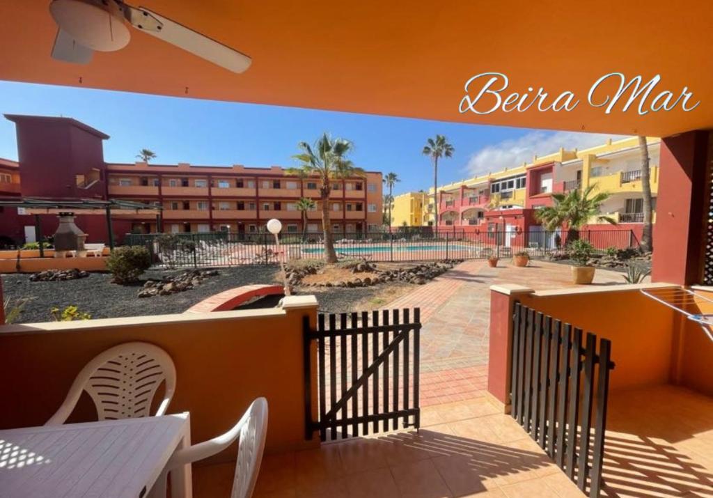 a balcony with a fence and some buildings at Beiramar La Caleta Fuerteventura, Piscina y wifi Gratis junto al Atlántico in Parque Holandes