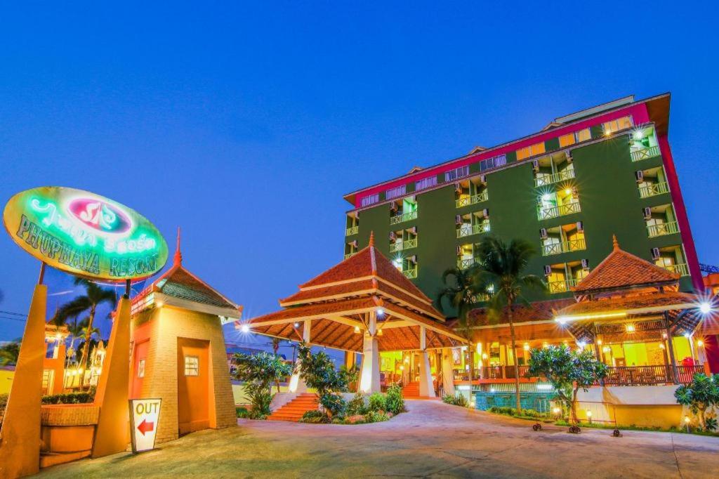 a large green building with a sign in front of it at Phuphaya Resort Pattaya in Pattaya South