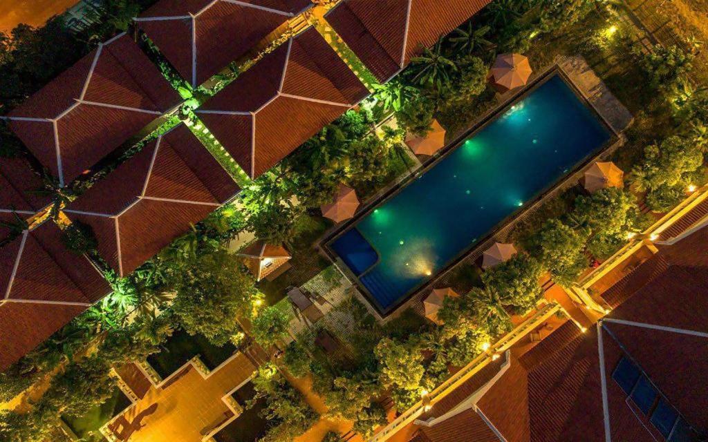 an overhead view of a swimming pool at night at Amour D' Angkor in Phumĭ Réach Born (1)