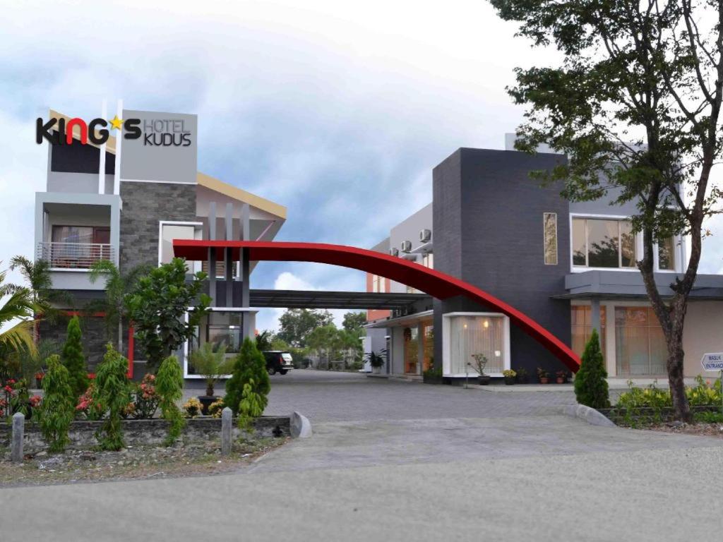 a red arch in front of a building at Hotel Kings Kudus in Kudus