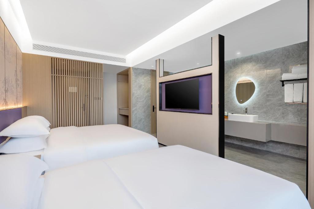 Postel nebo postele na pokoji v ubytování New Century Mansion Hotel Cixi Guanhaiwei