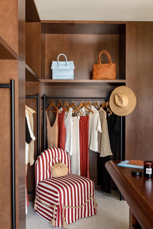 a walk in closet with two chairs and a bench at Regina Experimental Biarritz in Biarritz