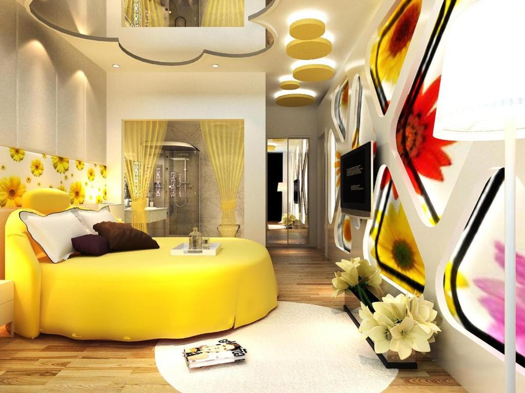 a bedroom with a large yellow bed in it at Guiin Homing Hotel in Guilin