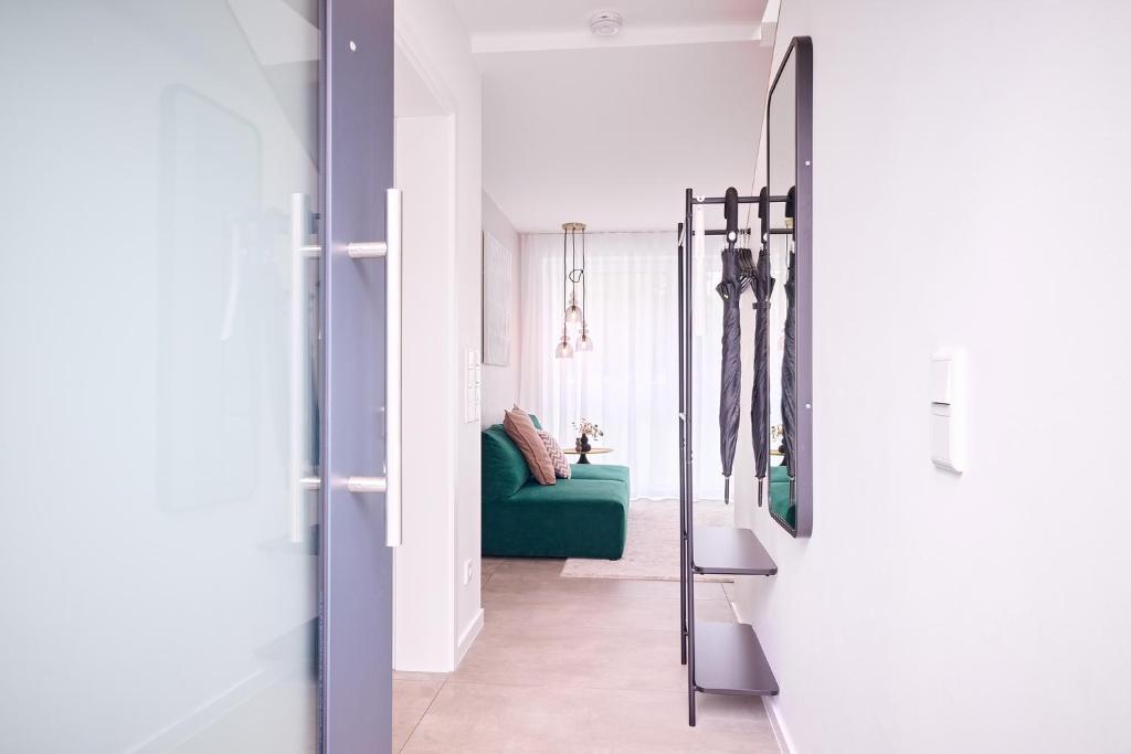 a hallway with a green couch in a room at Xzllenz - 4 Schlafzimmer, Zentral, Parken, U-Bahn, 2 Bäder, 4 Smart-TV, optional Einzelbett in Nürnberg