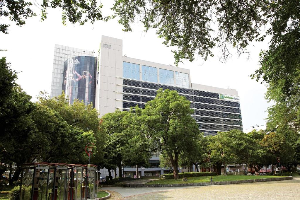 a large building with a sign on the side of it at Holiday Inn Express Taichung Park by IHG in Taichung