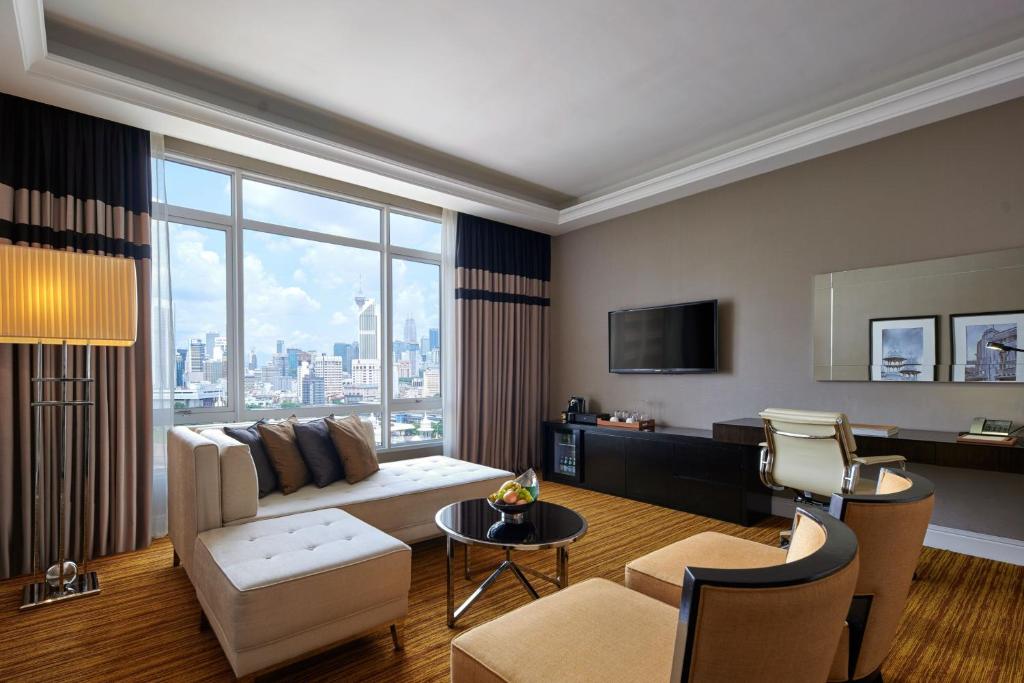A bright sitting room with a skyline window, television and a wall-length work surface.