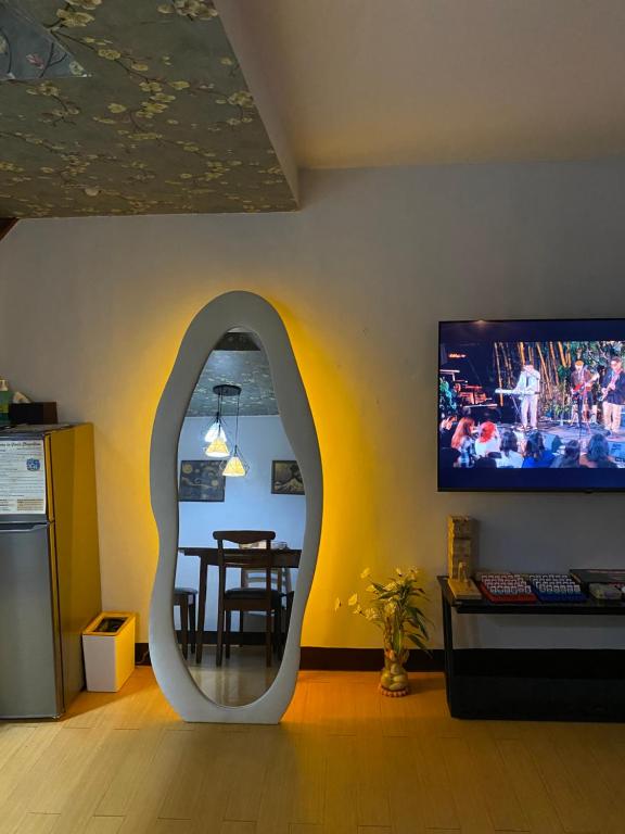 a living room with a table and a mirror at Viors Staycation in Cainta