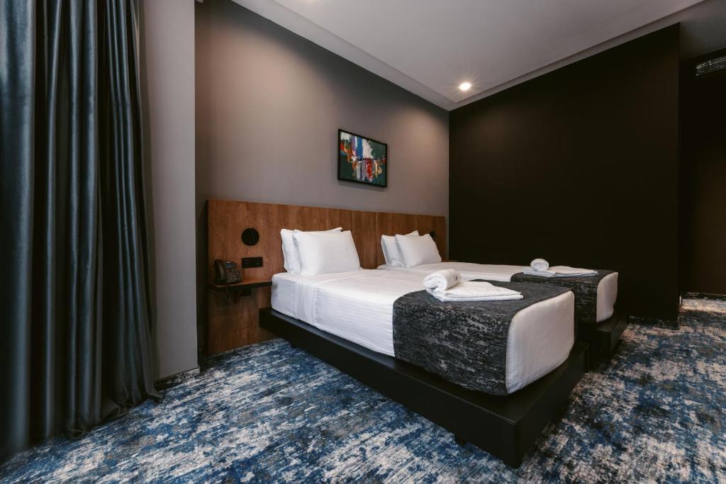 Postel nebo postele na pokoji v ubytování Hotel Splendid Tbilisi