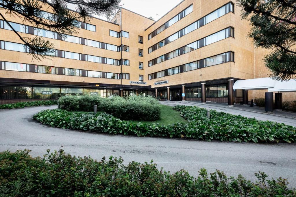 a building with a road in front of it at Scandic Kuopio in Kuopio