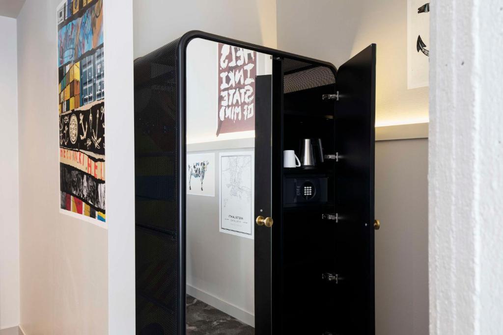 a mirror in a room with a black door at Radisson Blu Seaside Hotel, Helsinki in Helsinki