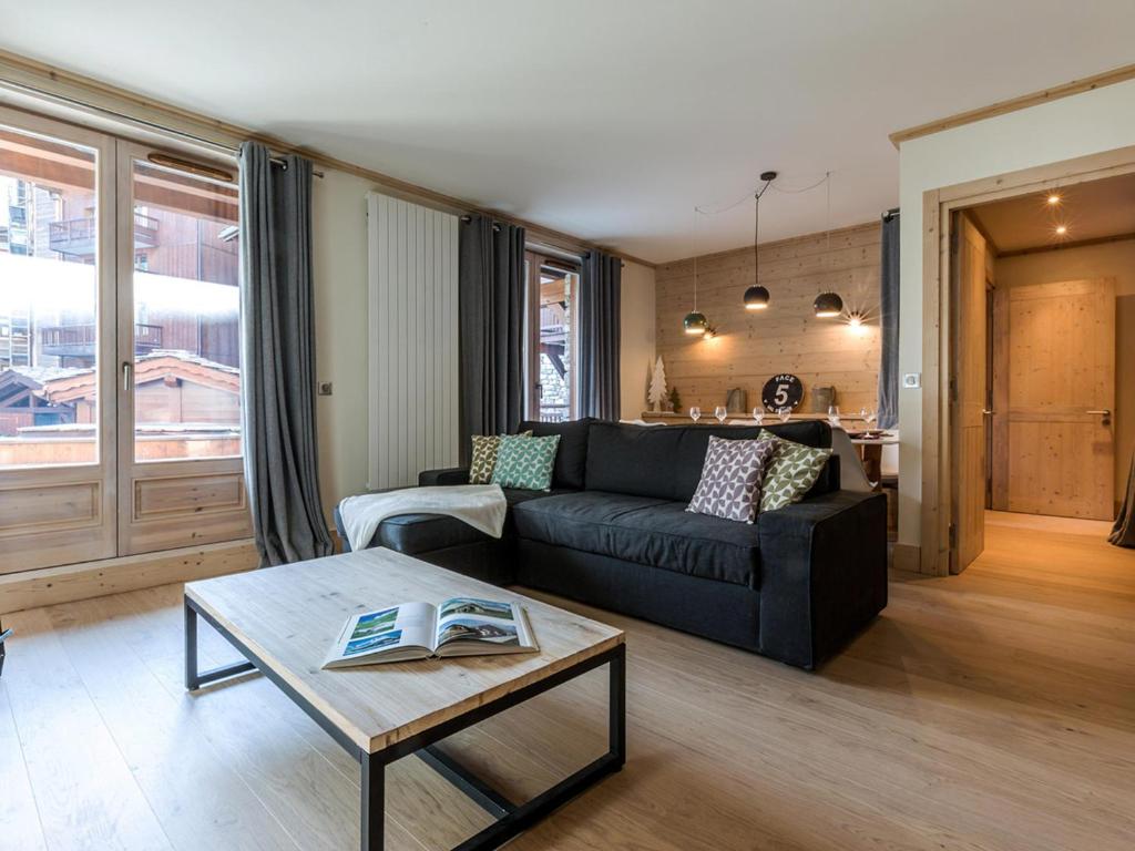 a living room with a black couch and a table at Appartement centre-ville, proche pistes et commerces, 6 pers., 2 ch., balcon, parking inclus - FR-1-519-5 in Val dʼIsère
