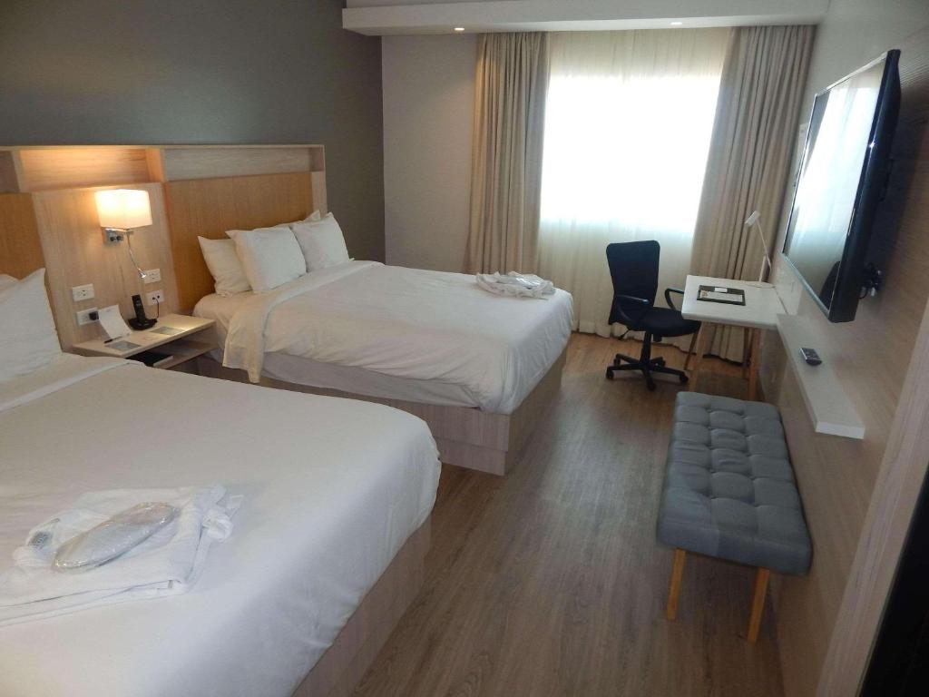 Postel nebo postele na pokoji v ubytování Radisson Colon 2,000 Hotel & Casino
