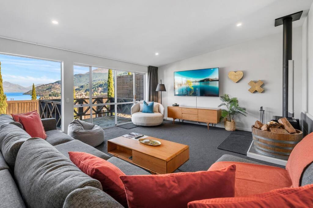 a living room with a couch and a table at Urban Oasis - Central with Lakeview in Queenstown