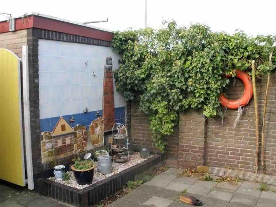 a wall with a mural of a lighthouse on it at De Stormmeeuw in Egmond aan Zee
