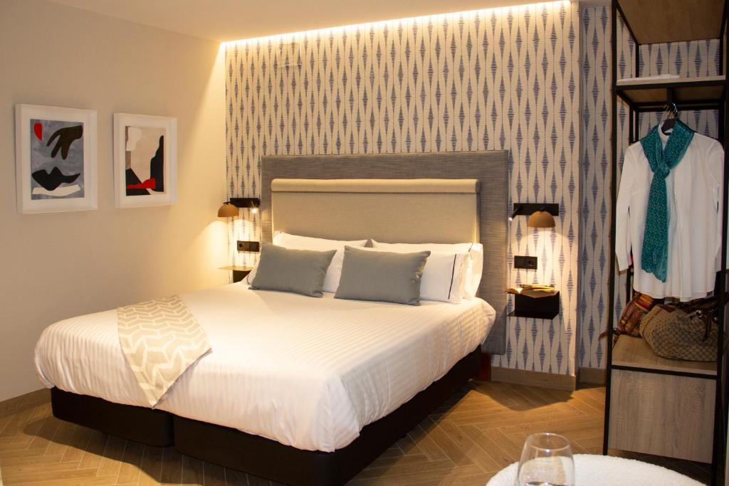 Postel nebo postele na pokoji v ubytování Puerta de la Ribera Suites
