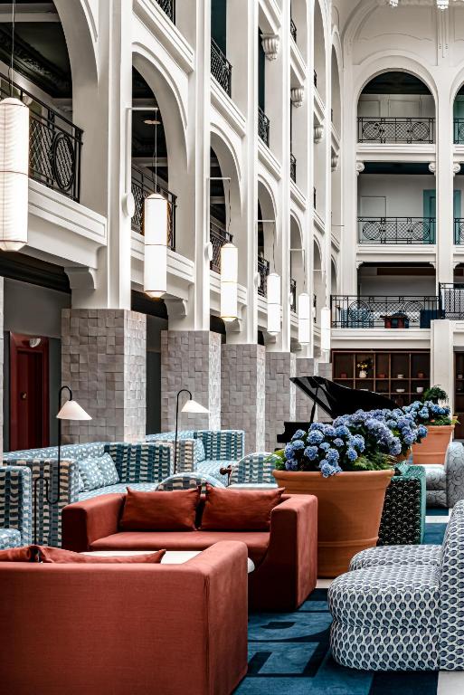 a lobby with couches and chairs in a building at Regina Experimental Biarritz in Biarritz