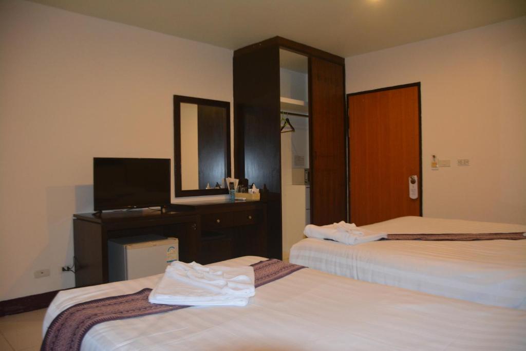 Postel nebo postele na pokoji v ubytování Patong Moon Inn Residence