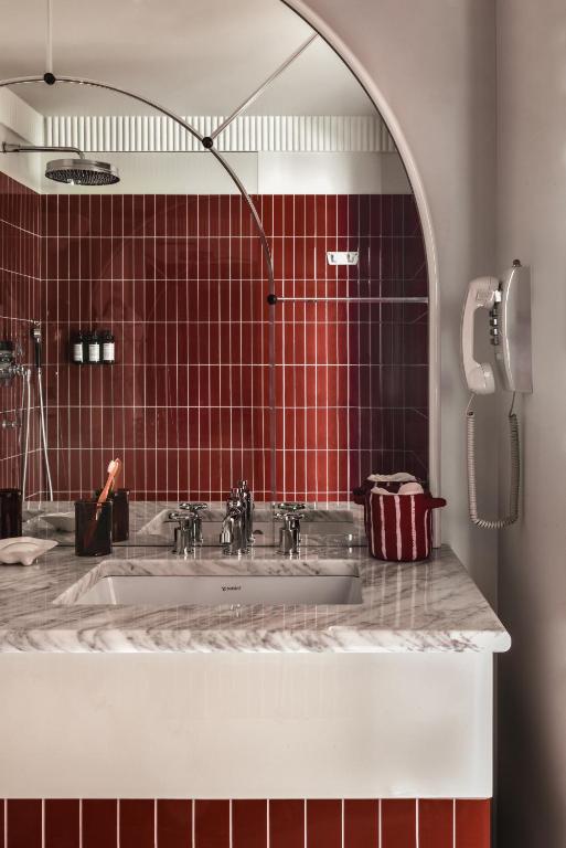 a bathroom with a sink and a mirror at Regina Experimental Biarritz in Biarritz