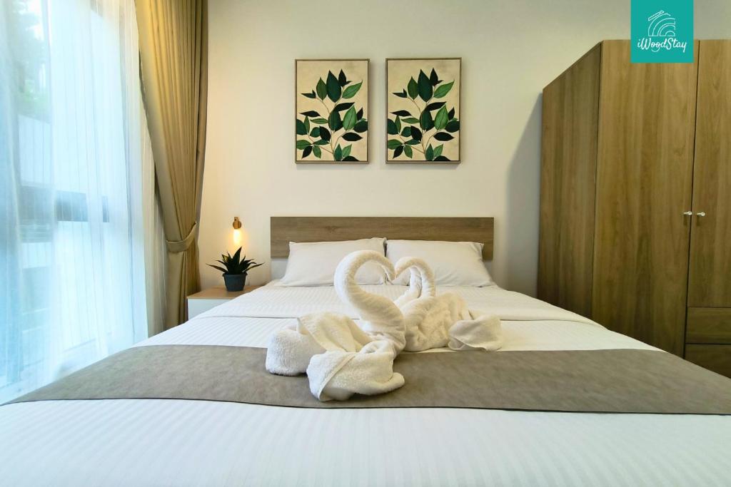 Ένα ή περισσότερα κρεβάτια σε δωμάτιο στο iWoodStay Mayabay Gamuda Cove Homestay