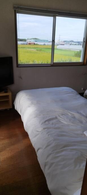Postel nebo postele na pokoji v ubytování はうす41マイルズ