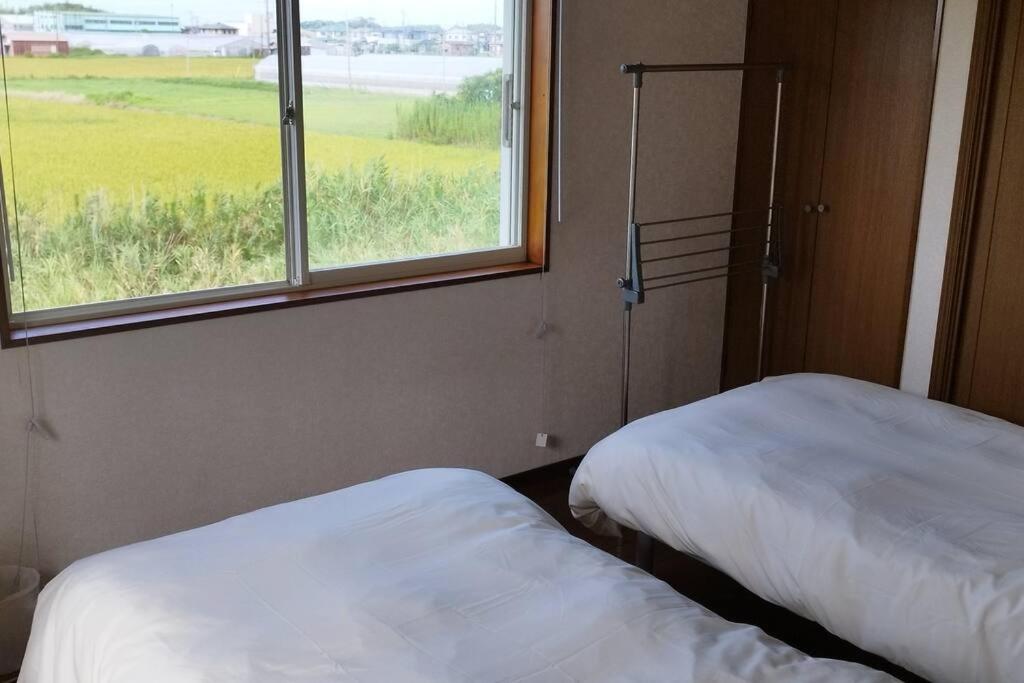 Postel nebo postele na pokoji v ubytování はうす41マイルズ