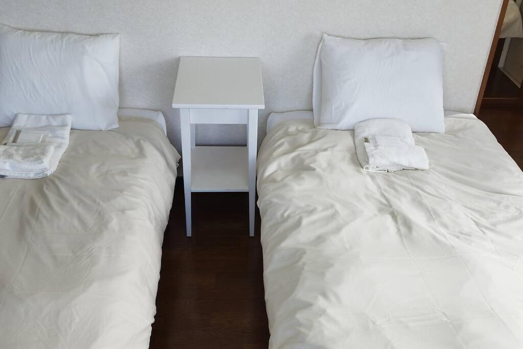 Postel nebo postele na pokoji v ubytování はうす41マイルズ