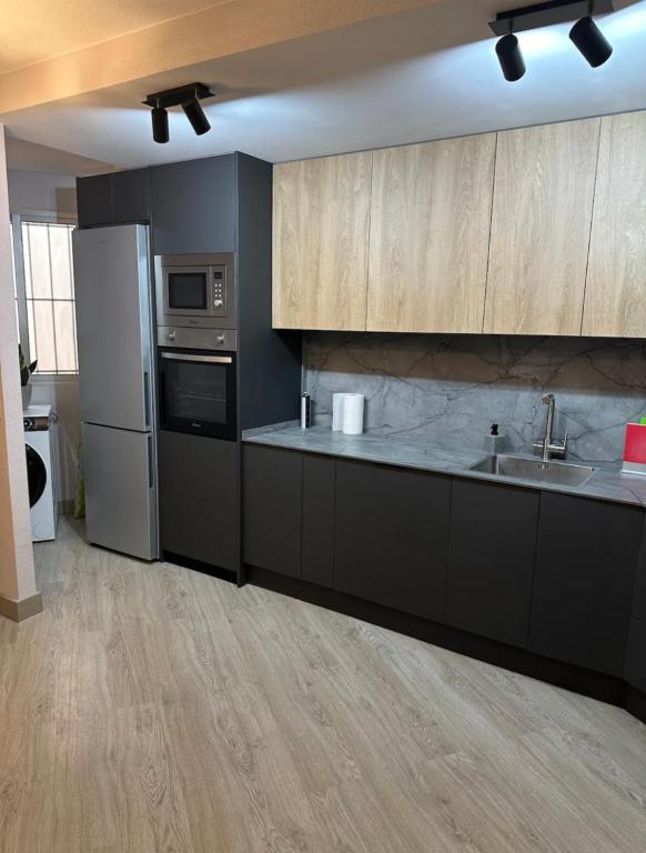 a kitchen with a sink and a refrigerator at Marina in Torrevieja