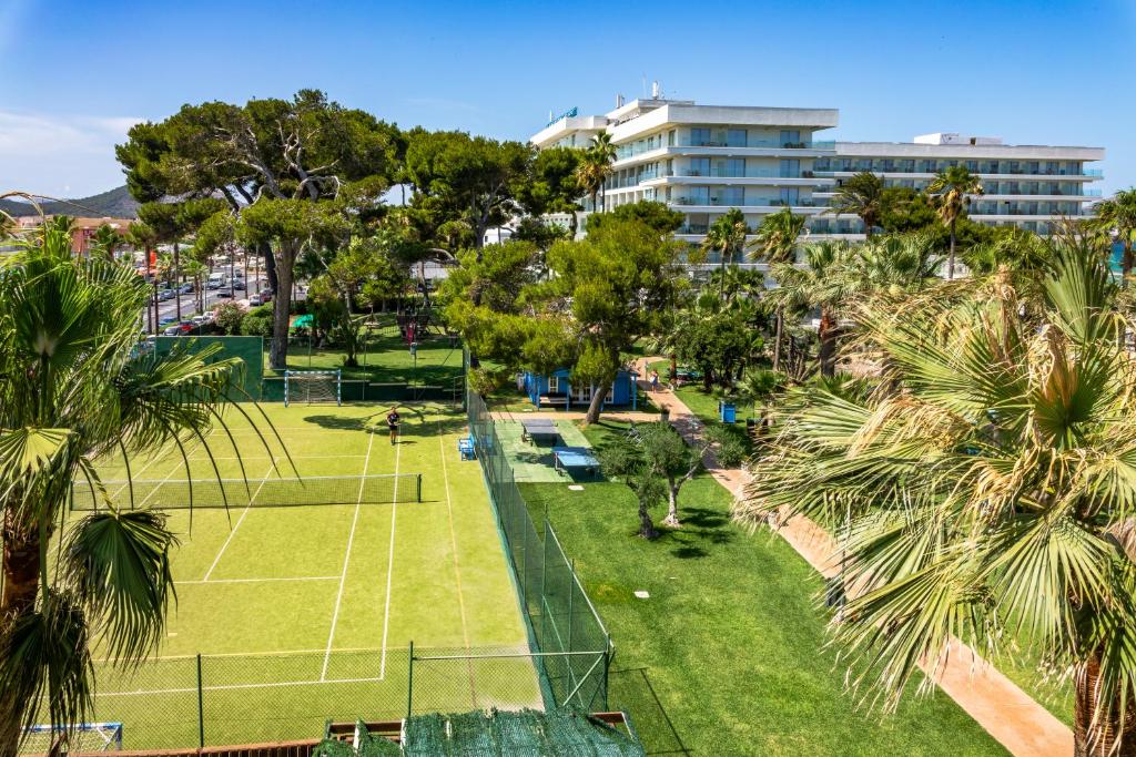 an aerial view of a tennis court with palm trees at Playa Esperanza Resort Affiliated by Meliá in Playa de Muro