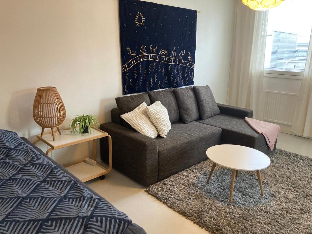 a living room with a couch and a table at Rovaniemi center apartment in Rovaniemi