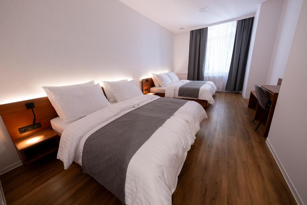 Postel nebo postele na pokoji v ubytování IT Centrum Apartments
