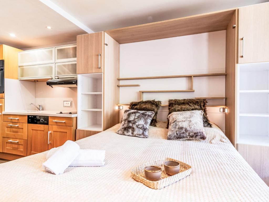 une chambre avec un grand lit avec deux oreillers dans l'établissement Studio Le Pramecou - Val Claret-16 by Interhome, à Tignes