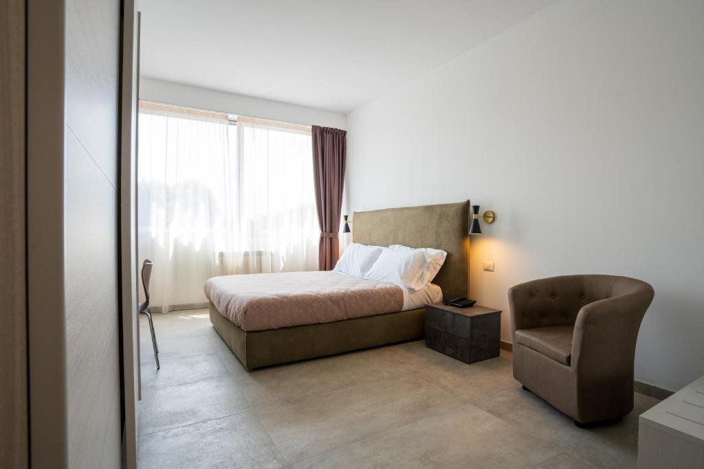 Postel nebo postele na pokoji v ubytování Hotel Bulà