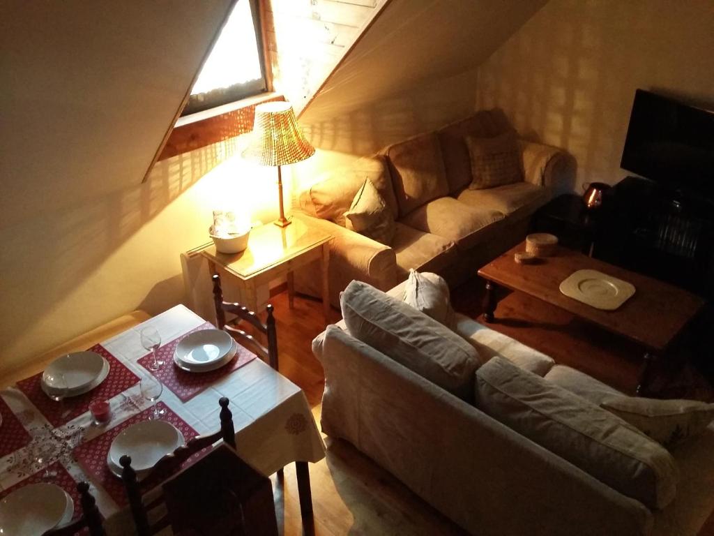a living room with a couch and a table at Apartamentos Tanau in Baqueira-Beret